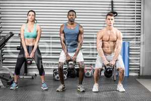 Fit people lifting dumbbells