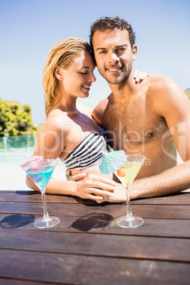 Happy couple embracing in the pool