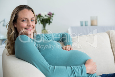 Pregnant woman touching her belly