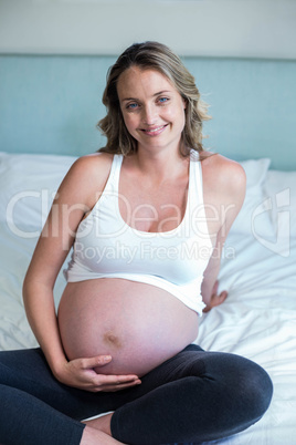 Pregnant woman resting on her bed