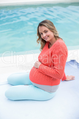 Pregnant woman relaxing outside