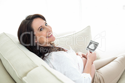 Pregnant woman looking at ultrasound scans