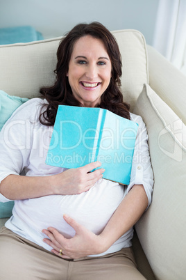 Pregnant woman reading a book