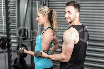 Couple posing with dumbbells