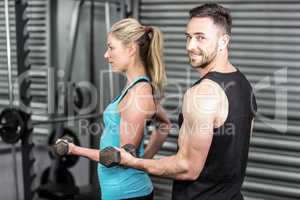 Couple posing with dumbbells