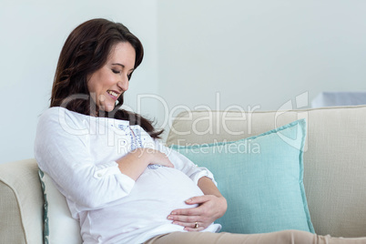 Pregnant woman resting on couch