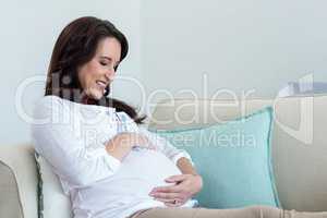 Pregnant woman resting on couch