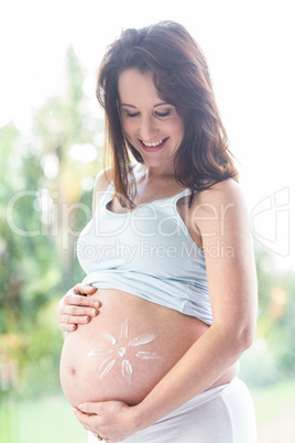 Pregnant woman with cream on her belly