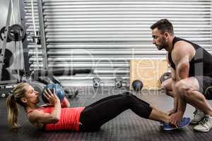 Fit couple doing abdominal ball exercise