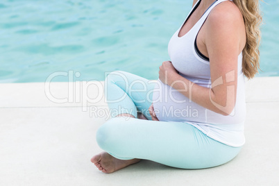 Pregnant woman touching her belly