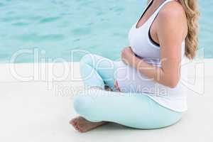 Pregnant woman touching her belly