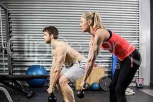 Couple lifting dumbbells together