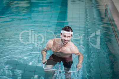 Smiling man doing underwater bike