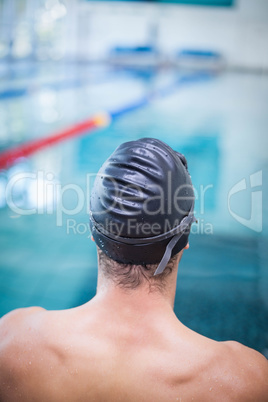 Handsome man wearing swim cap and goggles