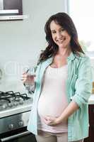 Pregnant woman holding glass of water