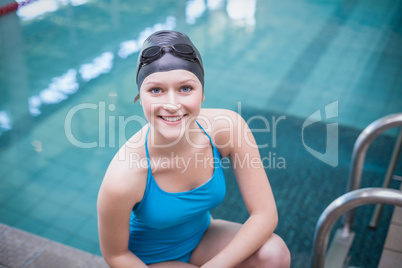Pretty woman wearing swim cap and swimming goggles