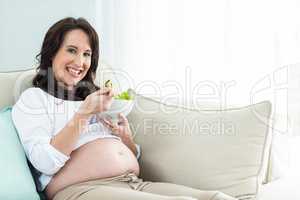 Pregnant woman eating salad