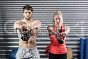 Couple lifting dumbbells together