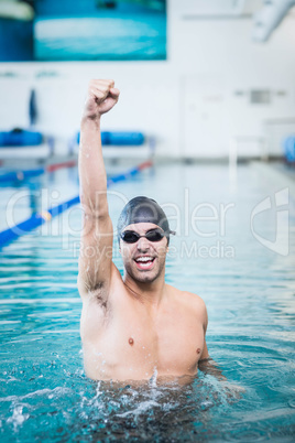 Handsome man triumphing with raised arms