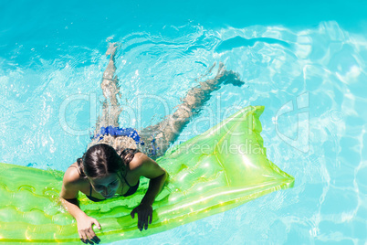 Woman in the pool holding lilo