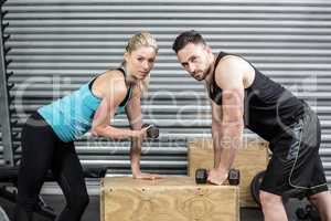 Couple lifting dumbbells together