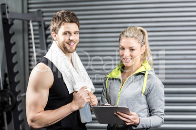 Smiling fit couple taking notes