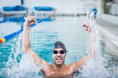 Handsome man triumphing with raised arms