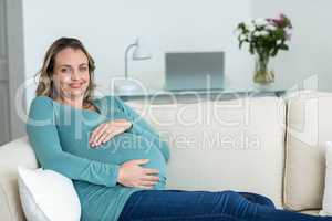 Pregnant woman touching her belly