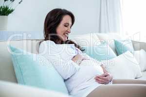 Pregnant woman sitting in the living room