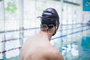 Fit man wearing swim cap and goggles