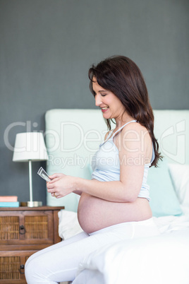 Pregnant woman looking at ultrasound scans