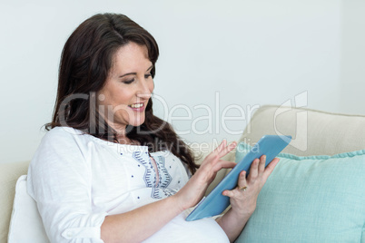 Pregnant woman resting on couch