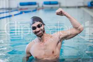 Smiling man triumphing with raised arm
