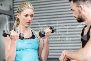 Fit woman lifting dumbbells