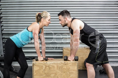 Couple lifting dumbbells together