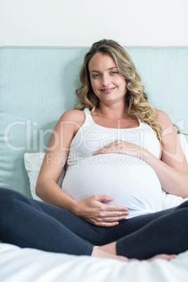 Pregnant woman touching her belly