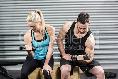 Couple lifting dumbbells together