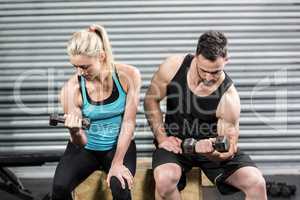 Couple lifting dumbbells together