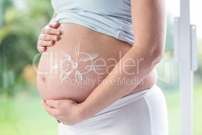 Pregnant woman with cream on her belly