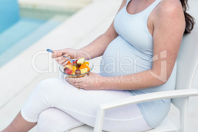 Pregnant woman eating fruit