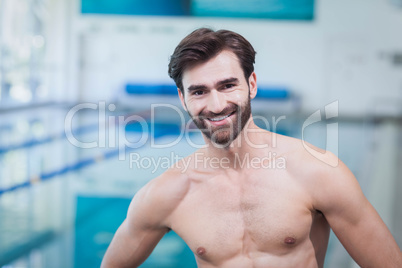 Handsome shirtless man standing with hands on hips