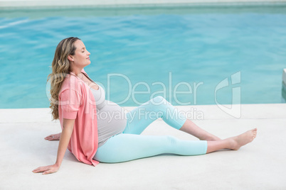 Pregnant woman relaxing outside