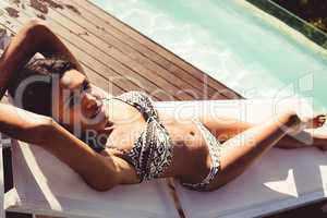 Fit woman lying on deck chair