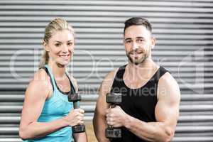 Couple lifting dumbbells together