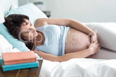 Pregnant woman resting on her bed