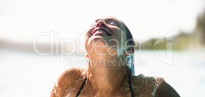 Beautiful woman in the pool looking up