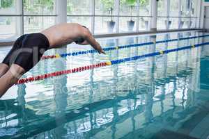 Fit man diving in the water