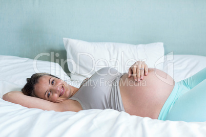 Pregnant woman lying on her bead