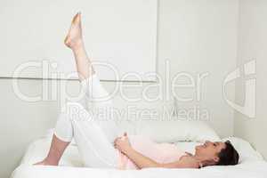 Pregnant woman lying on bed