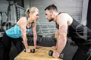 Couple lifting dumbbells together